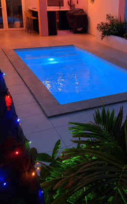 flamingo-bay-villas-aruba-private-pool-evening.jpg Flamingo Bay Villas in Savaneta, Aruba with a private swimming pool illuminated at night, tropical gardens, BBQ area and romantic outdoor lighting.