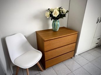 Bedroom dresser with vase of white flowers at Villa Sunrise, Flamingo Bay Villas Aruba.