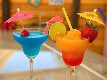 Colorful tropical cocktails with fruit garnishes at the outdoor bar, Villa Sunrise in Aruba.