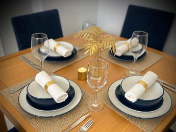 Elegant dining table set for four with modern tableware at Villa Sunrise, Flamingo Bay Villas Aruba.