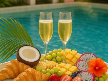 Champagne glasses with fruit and pastries on a tray by the private pool at Villa Sunrise, Flamingo Bay Villas Aruba.